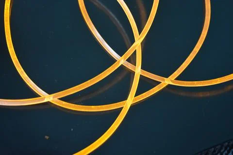 Light transparent wire, cable, polyethylene tubes, rods of yellow lines. Stock Photos