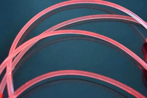 Light transparent wire, cable, polyethylene tubes of red, orange, yellow, pink. 스톡 사진