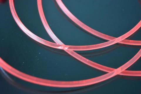 Light transparent wire, cable, polyethylene tubes of red, orange, yellow, pink. Stock Photos