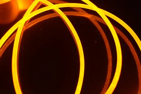 Light transparent wire, cable, polyethylene tubes, rods of yellow lines. Stock Photos