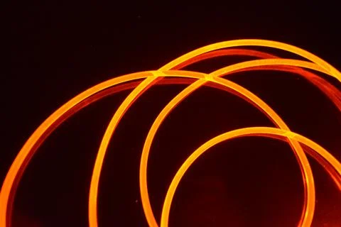 Light transparent wire, cable, polyethylene tubes, rods of red, orange. 스톡 사진