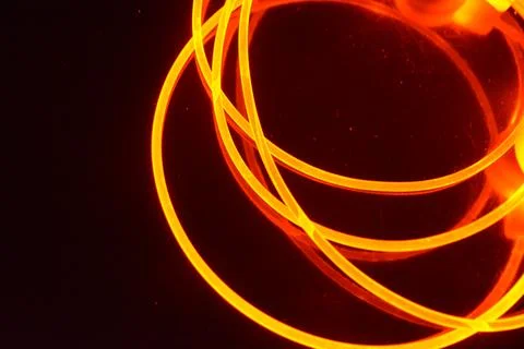 Light transparent wire, cable, polyethylene tubes, rods of red, orange. 스톡 사진