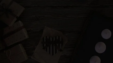 Light travels over gift boxes on a desktop from bottom to top Stock Footage 83943131