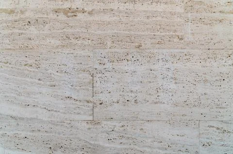 Light travertine tile wall showing subtle veins in pale stone Stock Photos