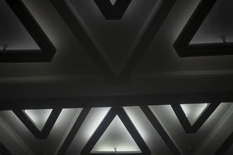 Light triangle. Lamp on ceiling. Light design. Architecture of 20th century. Stock Photos
