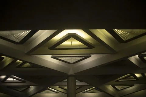 Light triangle. Lamp on ceiling. Light design. Architecture of 20th century. Stock Photos
