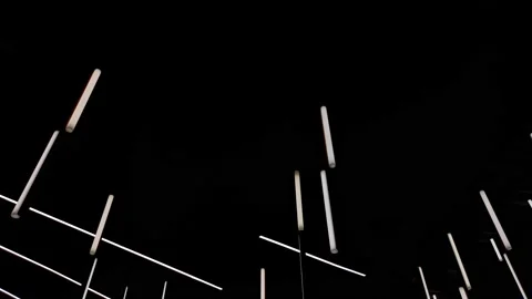 Light tubes hanging from the ceiling in the dark room Video stock 159440736