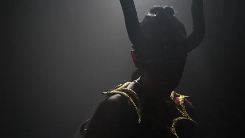 The light turns on, female devil with red eyes and horns, slow motion Stock Footage 138139911