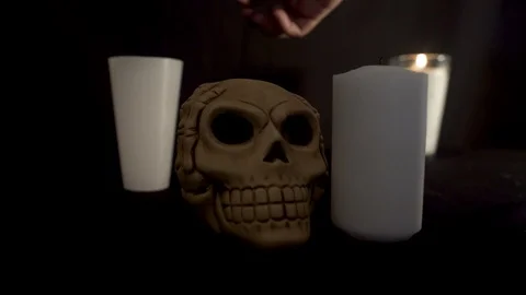 Light up two candles with a skull in the center Stock Footage 96676830