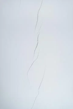 Light wall with a crack. Background Stock Photos