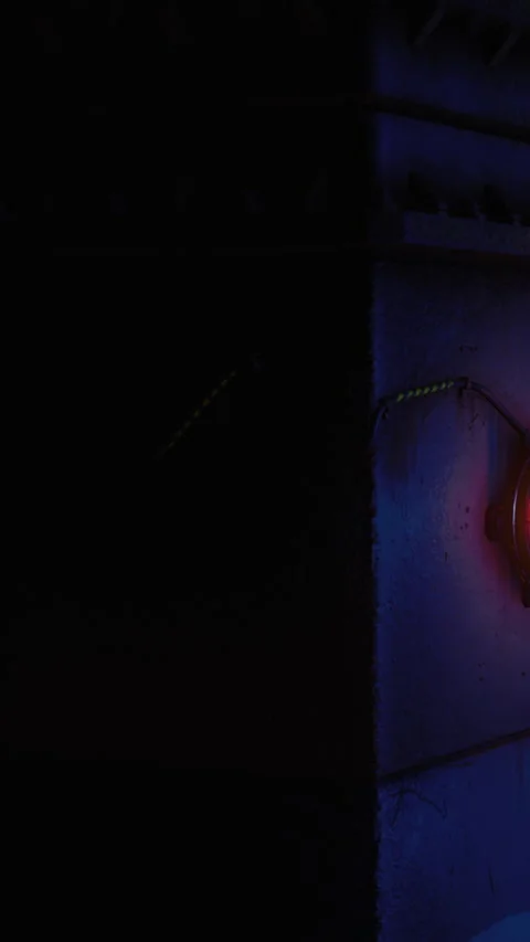 Light on wall at night creates shadow shapes in dark space near corner Stock Footage 332213193