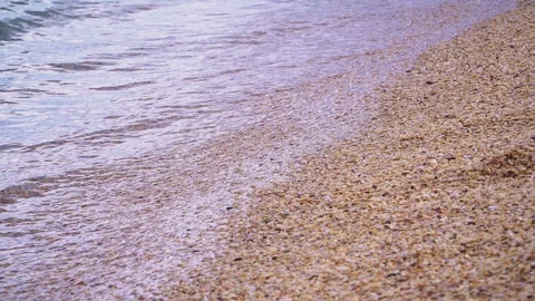 Light wave rolls on the sandy shore close up Stock Footage 105451700