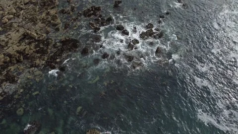Light Waves Crashing around a Rocky Beach - 2.7k 60fps Stock Footage