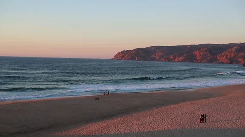 Light waves on the deserted shore of the ocean against the backdrop of rocks Stock Footage 130001931