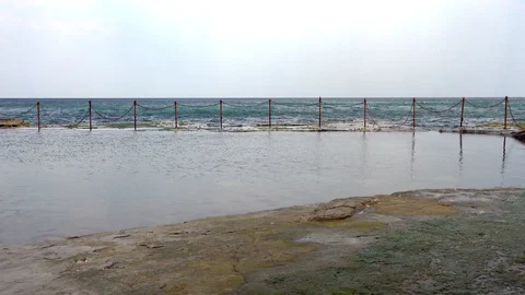 Light waves go through the water near the cliff Stock Footage 121651694