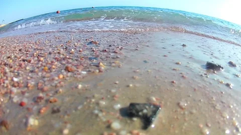 Light waves surf surf on the sandy shore on a clear sunny day, the Red Sea, a Stock Footage 115070237