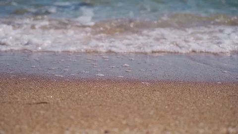 Light waves wash the beautiful sandy beach Stock Footage 126786210