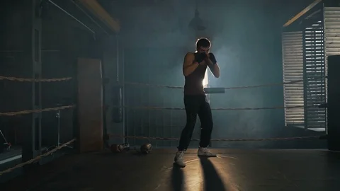 Light weight boxer training on the ring in vintage stylized gym Stock Footage 87840853