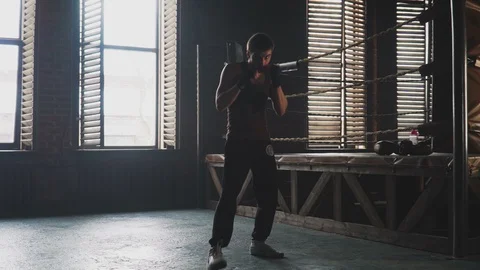 Light weight boxer training in vintage stylized gym near the ring Stock Footage 87842493
