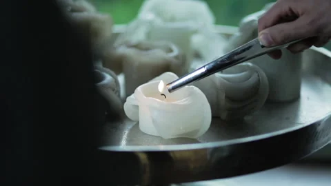 Light a white candle on a table 스톡 동영상 133497189