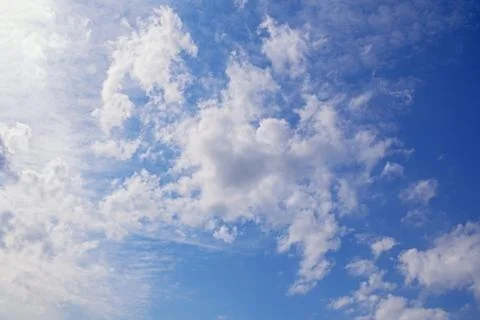 Light white clouds in blue sky on sunny day Stock Photos