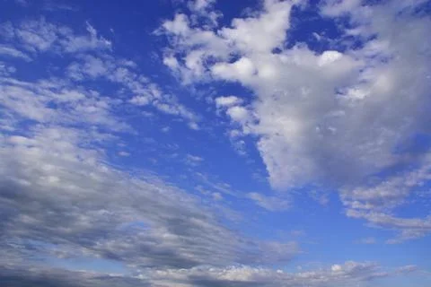 Light white clouds in the blue sky. Great background for graphic projects Photos