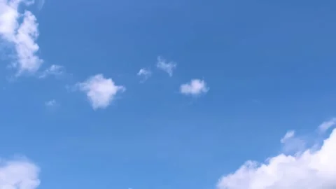 Light white clouds flew past in the bright blue sky. The summer of the sun's sco Stock-Footage 163710805