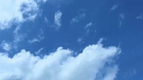 Light white clouds flew past in the bright blue sky. The summer of the sun's sco Stock-Footage 163710811