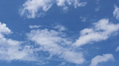 Light white clouds flew past in the bright blue sky. The summer of the sun's sco Stock-Footage 163710836