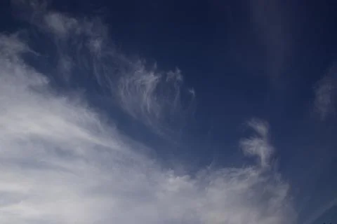 Light white translucent cirrus clouds in the blue sky. Natural natural backgr Stock Photos