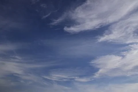 Light white translucent cirrus clouds in the blue sky. Natural natural backgr Stock Photos