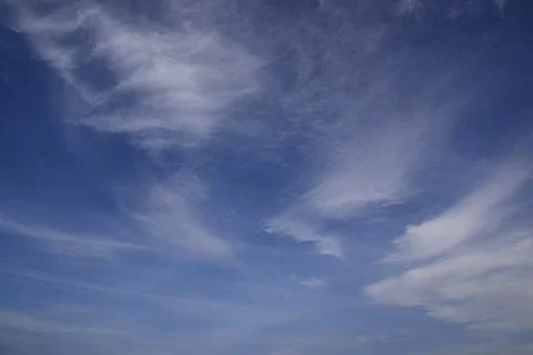 Light white translucent cirrus clouds in the blue sky. Natural natural backgr Stock Photos