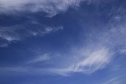 Light white translucent cirrus clouds in the blue sky. Natural natural backgr Stock Photos