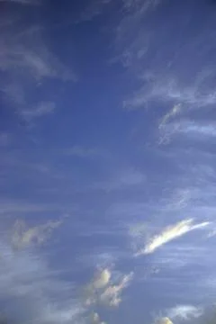 Light white translucent cirrus clouds in the blue sky. Natural natural backgr Stock Photos