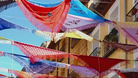 Light wind moving colourful shawls on festive city day in La Latina distric.. Stock Footage 327857521
