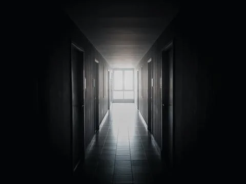 The light at the window at end of the way on dark mysterious corridor in buil Stock Photos