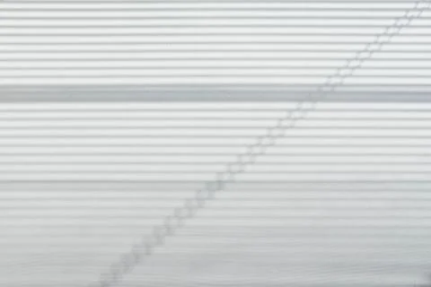 The light from the window falls on the wall, the shadow lines from the blinds Foto stock