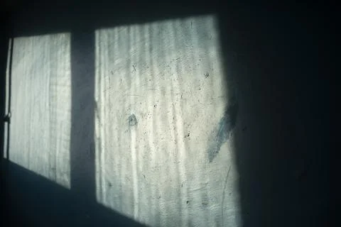 Light from window on wall. Light on blue wall. Interior details. Stock Photos