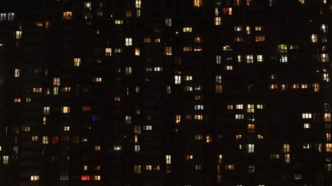 Light in the windows of a multi-storey building. Time-lapse. Night apartment  Vídeo Stock 128128760
