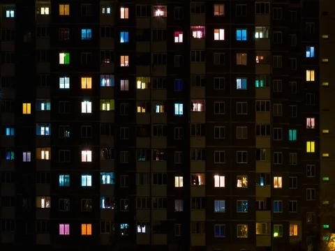 Light in the windows of a multistory building. Stock Footage 84878933