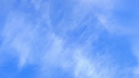 Light wispy cirrus clouds floating in a bright blue sky. Cirrus clouds. Summer Stock Footage 343573903