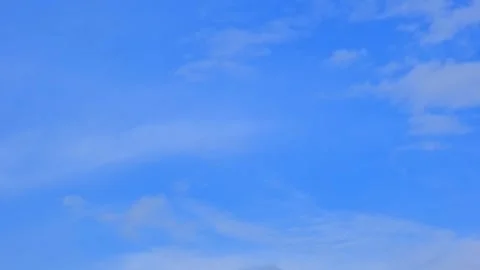 Light wispy clouds floating in a bright blue sky. From bottom to top view Stock Footage 343573932