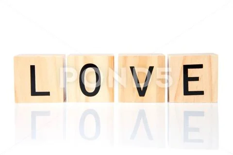 Light wood blocks with LOVE spelled out reflected on a white surface, isolate Stock Photos
