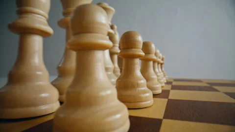 Light wooden chess figures positioned on board closeup. Pieces standing in row Stock Footage 332310458