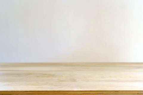 Light wooden table surface against a white wall for product display 스톡 사진