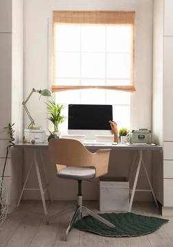 Light work place with computer near window at home. Interior design Stock Photos