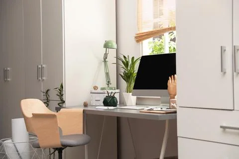 Light work place with computer near window at home. Interior design Stock Photos