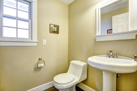 Light yellow bathroom with window Stock Photos