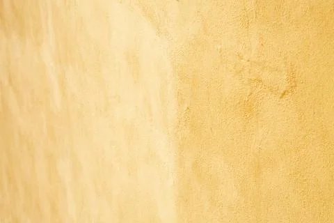 Light yellow pastel wall plaster. Background picture. Concrete surface panted in Stock Photos