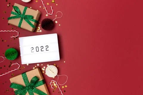 Lightbox with 2022 numbers. Frame made from New Year decorations. Stock Photos